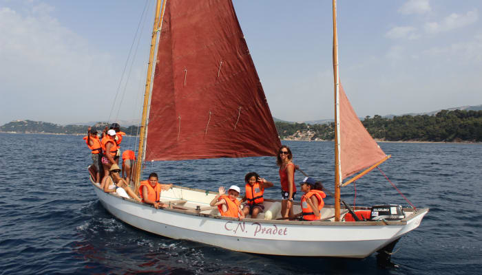 Enfants en gilets de sauvetage orange naviguant sur un voilier traditionnel dans le Golfe du Morbihan lors d'un séjour nature