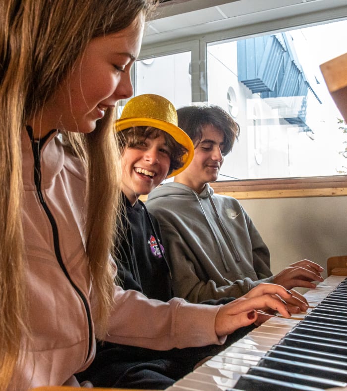 Adolescents jouant du piano ensemble lors d'un atelier de loisir créatif en séjour
