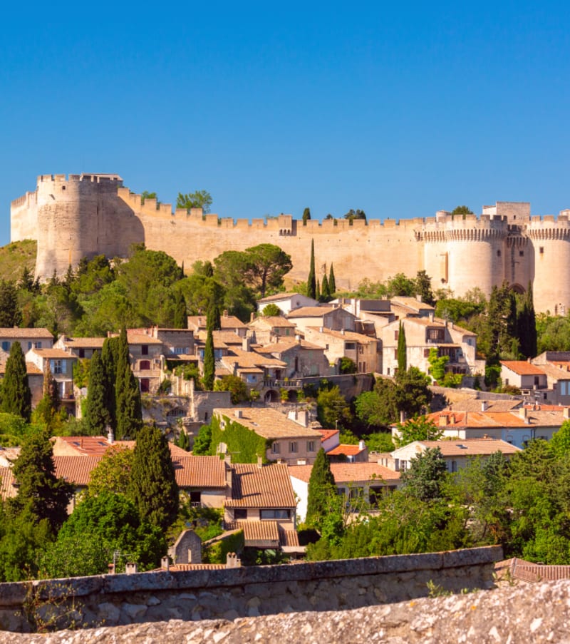 Forteresse médiévale dominant le village de Villeneuve lez Avignon sous le soleil de Provence avec cyprès et maisons en pierre